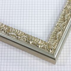 This 1-1/4 " ornate frame features an elegant small floral compo design finished in bright silver. Its intricate detailing and luminous metallic tone add a sophisticated, timeless charm—perfect for enhancing classic artwork, portraits, or elegant décor pieces.
